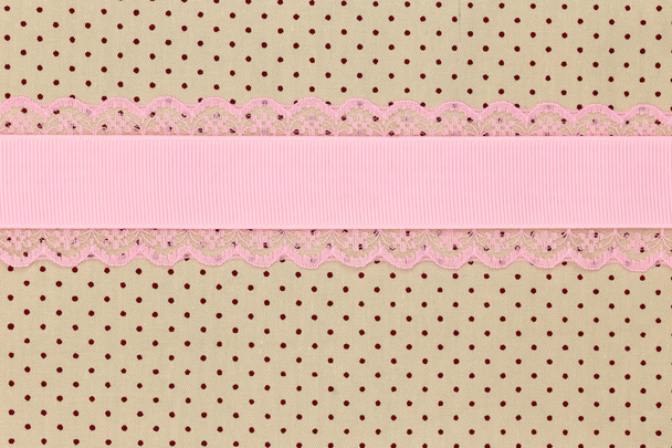 Retro beige polka dot textile background with pink ribbon  - Photo, Image