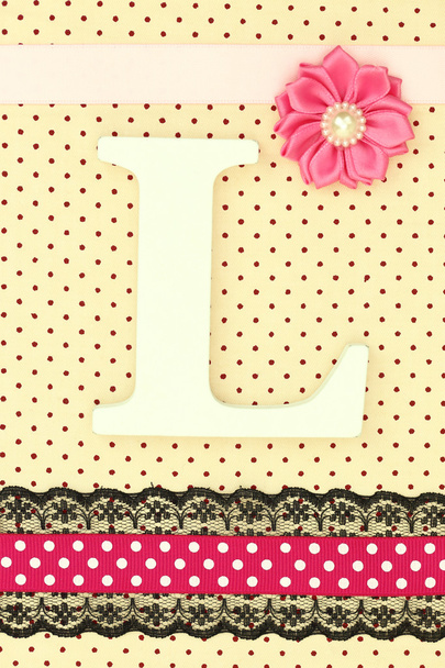 Wooden letter L on polka dots background - Photo, Image