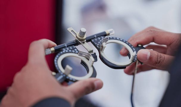 Glasses, trail frame and lens with test and ophthalmologist tools, woman hands zoom with healthcare for eyes and prescription. Optometry, eye care and optometrist, medicine and chart with measurement. - Foto, afbeelding