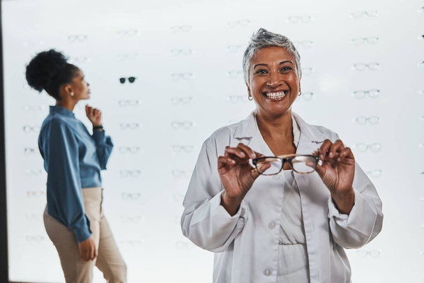 Portrait, woman and smile of optician with glasses in shop or store for frames, eyewear or eye care spectacles. Ophthalmology, vision and happy, proud or confident senior female medical optometrist - Foto, afbeelding