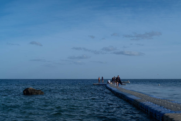 panton in the red sea and people walking on it in the early morning - Foto, immagini