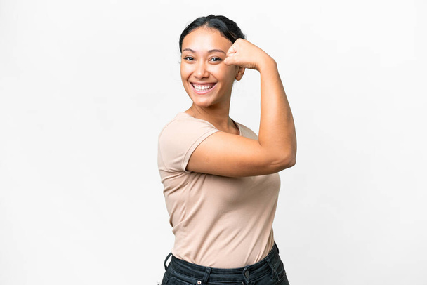 Young Uruguayan woman over isolated white background doing strong gesture - Foto, afbeelding