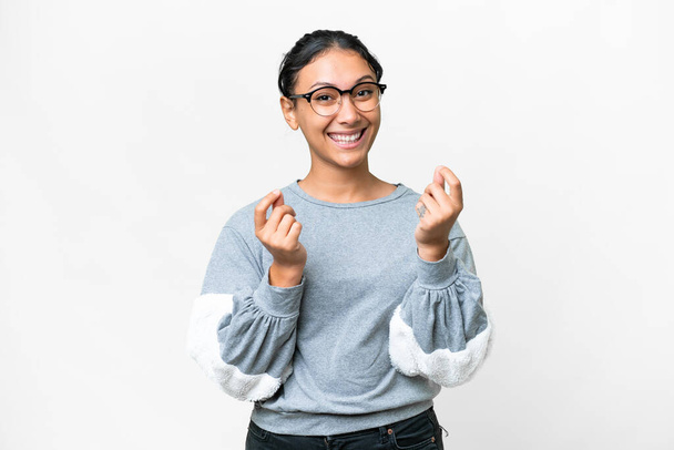 Young Uruguayan woman over isolated white background making money gesture - Φωτογραφία, εικόνα
