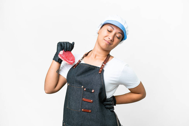 Butcher woman wearing an apron and serving fresh cut meat over isolated white background suffering from backache for having made an effort - Fotografie, Obrázek