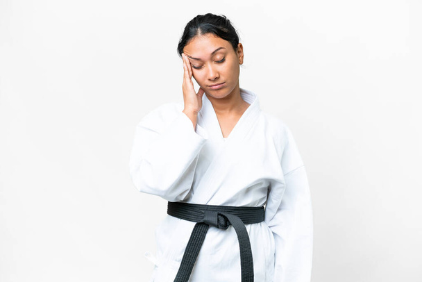 Young Uruguayan woman doing karate over isolated white background with headache - Zdjęcie, obraz