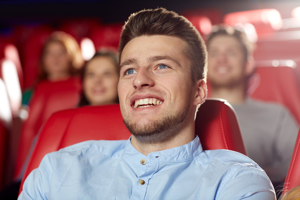 happy young man watching movie in theater - Foto, Imagem