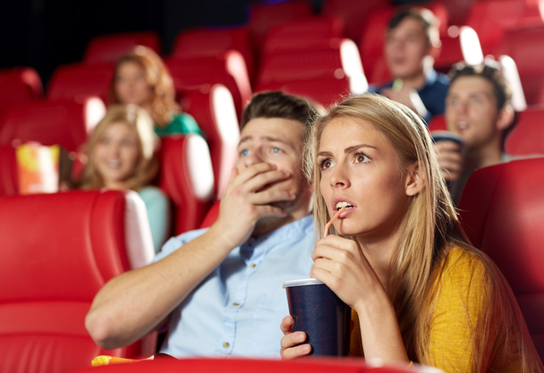 friends watching horror movie in theater - Foto, afbeelding