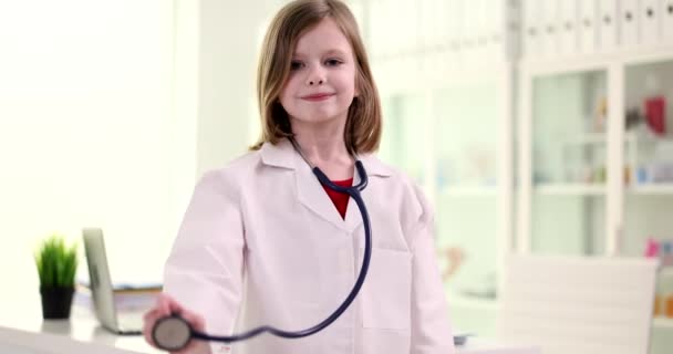 Child girl holding stethoscope and playing doctor. Children health care services concept - Footage, Video