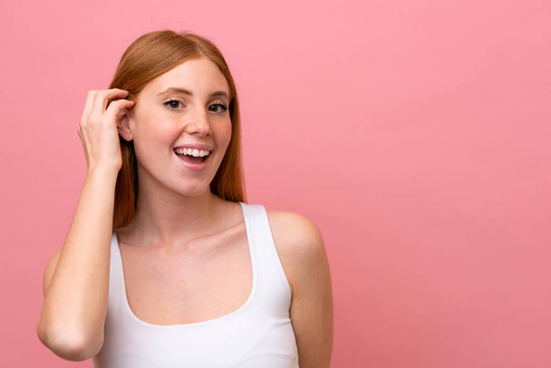 Young redhead woman isolated on pink background - Fotografie, Obrázek