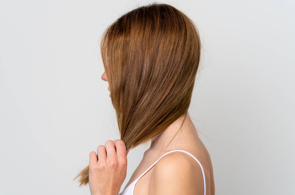 Young English woman touching her hair. Close up portrait - Valokuva, kuva