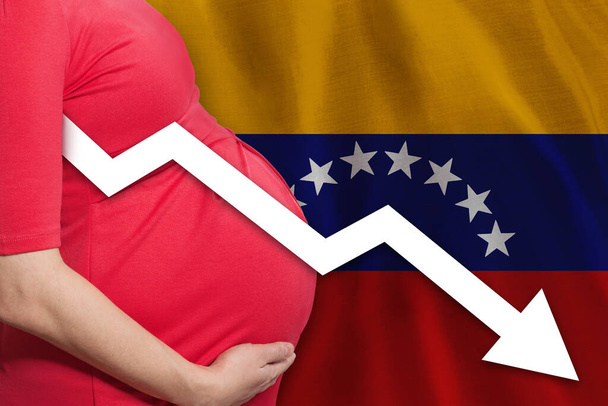 Pregnant woman on Venezuelan flag background. Falling fertility rate in Venezuela - Foto, afbeelding