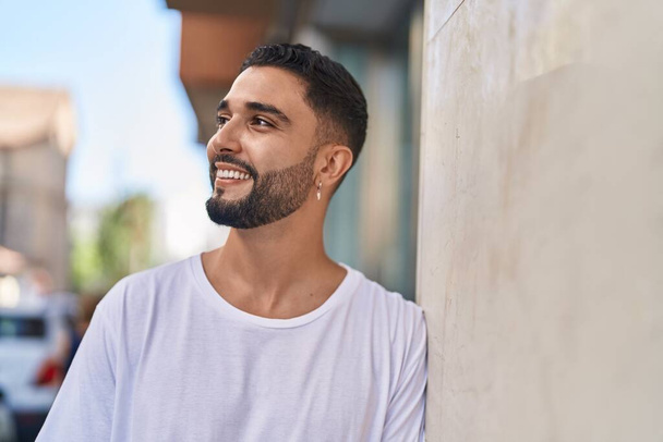 Young arab man smiling confident looking to the side at street - Fotografie, Obrázek