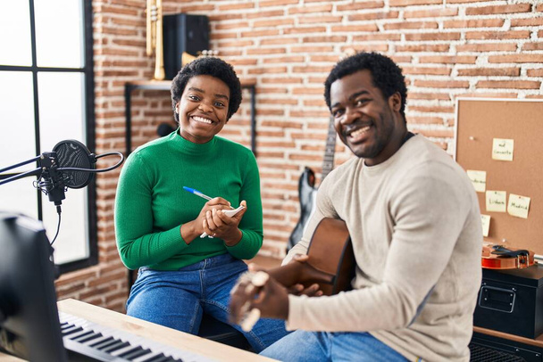 African american man and woman music group compising song at music studio - Photo, Image