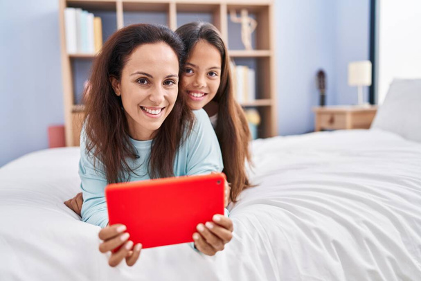 Kobieta i dziewczyna matka i córka za pomocą touchpad w sypialni - Zdjęcie, obraz