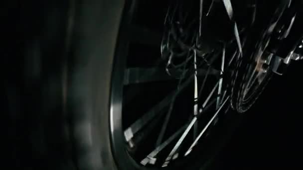 Electric dirt bike wheel stops spinning. Close-up. Brake disc and chain. - Footage, Video