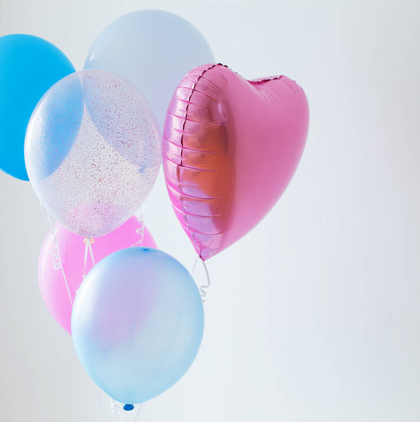 blue and pink balloons on white background - Φωτογραφία, εικόνα