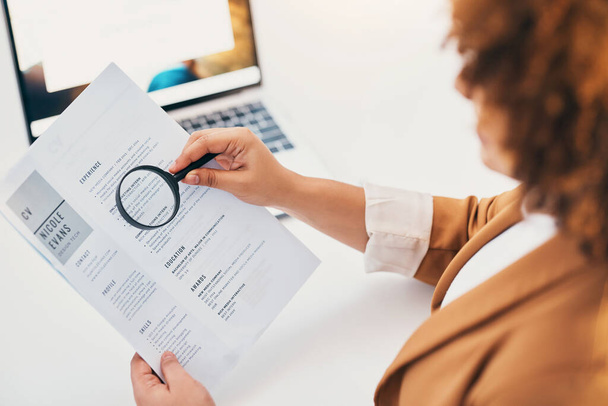 Hands, cv paper and magnifying glass at hr office with black woman, recruitment or focus at desk. Human resources, documents or zoom for hiring, opportunity or job for future employee with inspection. - Foto, Bild