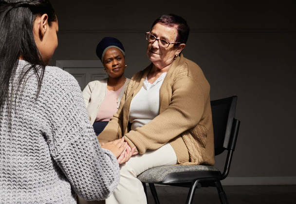 Support, women holding hands and group therapy with understanding, sharing feelings and trust talking in session. Mental health, grief or depression, sad senior woman with therapist sitting together - Fotó, kép
