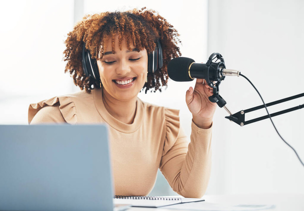 Laptop, microphone and media with a black woman presenter talking during a broadcast while live streaming. Influencer, talk show and radio with a female journalist or host chatting on a mic. - Fotografie, Obrázek