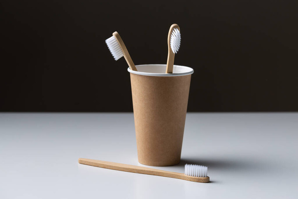 Toothbrush in a cardboard ecological cardboard cup, hygiene health care. - Fotografie, Obrázek