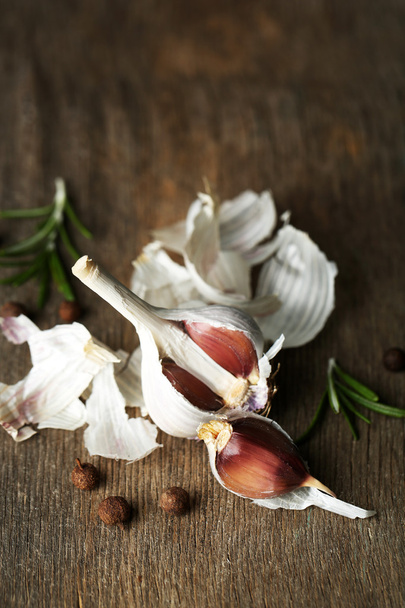 Raw garlic and spices on old wooden table - Photo, Image