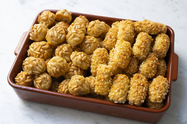 Penellets. Small sweets of various shapes, made from almond and potato dough, and covered with almonds or pine nuts. - Photo, Image