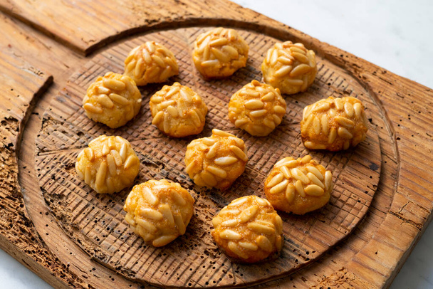 Penellets. Small sweets of various shapes, made from almond and potato dough, and covered with almonds or pine nuts. - Zdjęcie, obraz