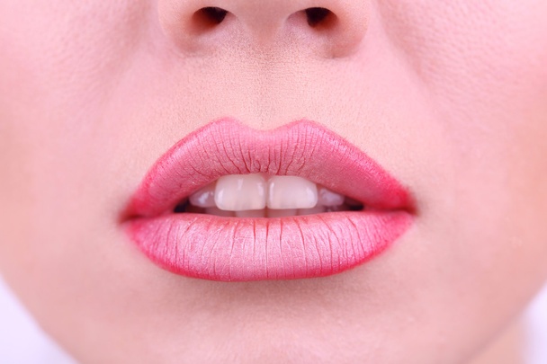 Aplicando batom nos lábios, no fundo branco
 - Foto, Imagem