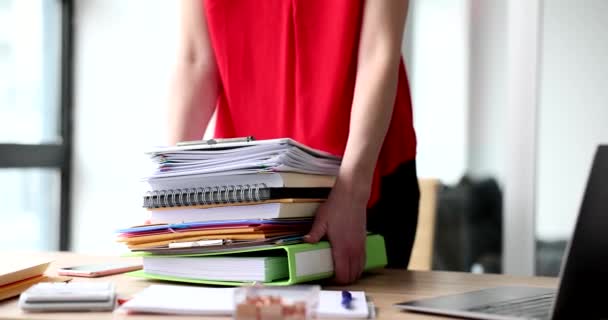 Woman secretary takes large stack of business documents from table. Overtime deadlines and paperwork - 映像、動画