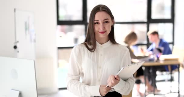 Corporate woman in office holds out hand and smiles. Handshake and greeting business partner - Záběry, video