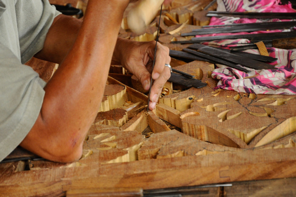 Skilled craftsman doing wood carving using traditional method - Photo, Image