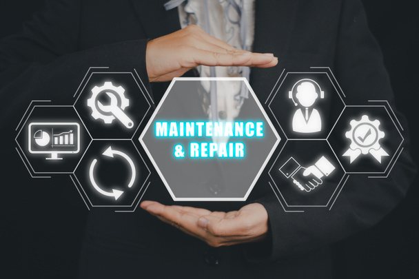 Maintenance and repair concept, Business person hand holding Maintenance and repair icon on virtuals screen. - Photo, image