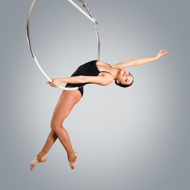 Plastic beautiful girl gymnast on acrobatic circus ring in flesh - Zdjęcie, obraz