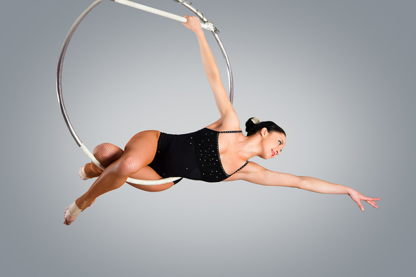 Plastic beautiful girl gymnast on acrobatic circus ring in flesh - Foto, immagini