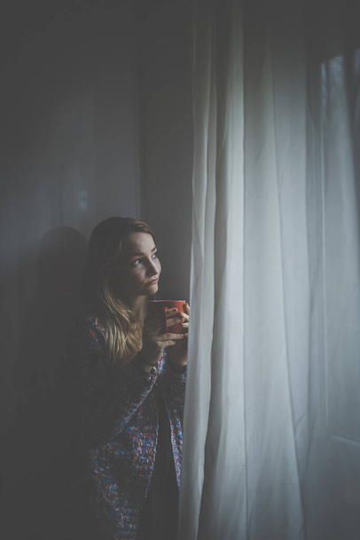 Cold, depressed, young woman at home feeling sad, lonely, anxious (color toned image) - Fotografie, Obrázek