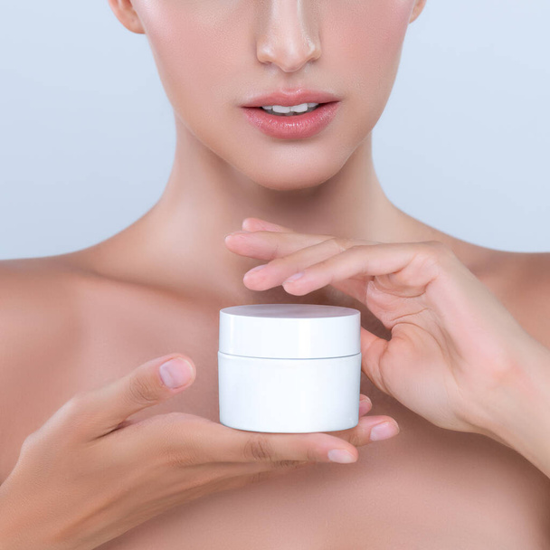 Alluring beautiful perfect cosmetic skin woman portrait hold mockup jar cream or moisturizer for skincare treatment, anti-aging product in isolated background. Natural healthy skin model concept. - Photo, Image