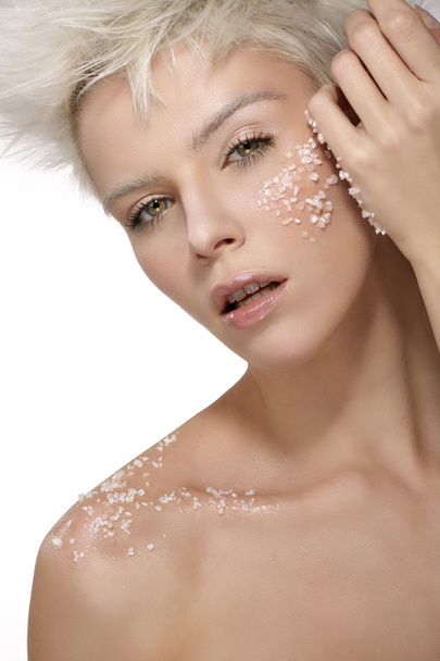 blond model applying a scrub treatment on the body an face - Foto, imagen