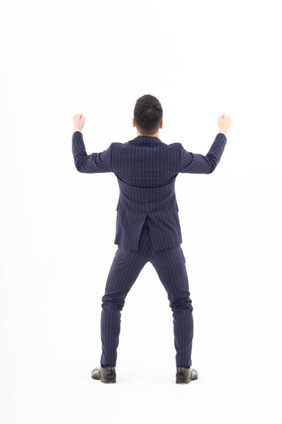 A man in a suit expressing joy and white background - Photo, Image