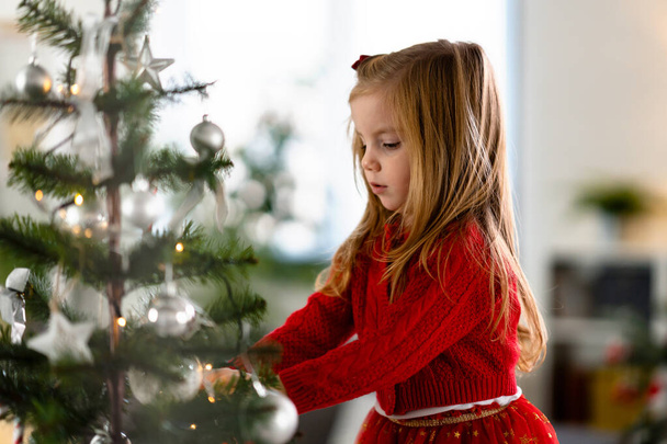 cute little girl decorating christmas tree - Photo, Image
