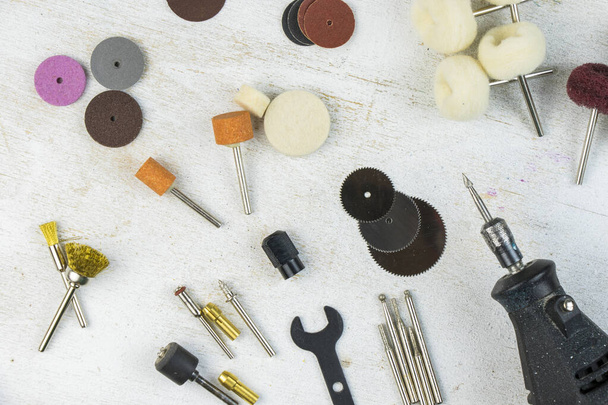 Dremel rotary kit, dremel heads, instrument for handwork on gray background - Foto, immagini