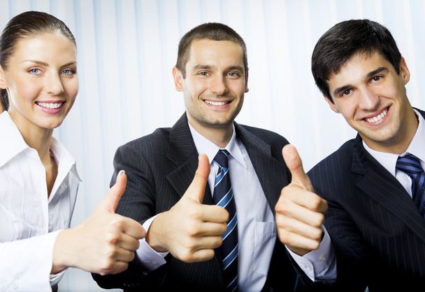 Happy successful gesturing businesspeople at office - Foto, afbeelding