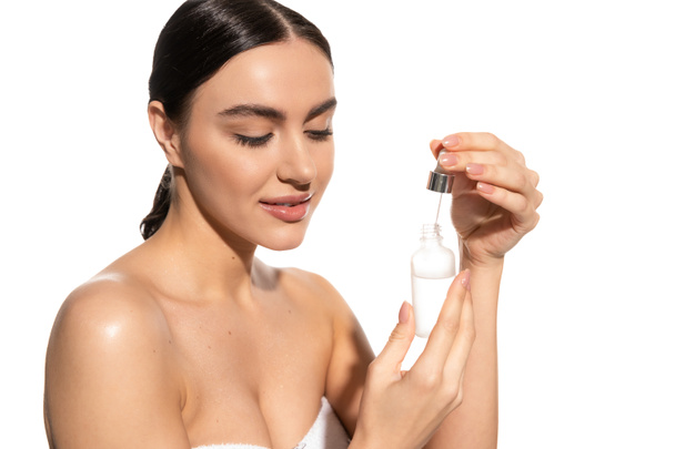 young woman with bare shoulders holding dropper with vitamin c serum isolated on white  - Φωτογραφία, εικόνα