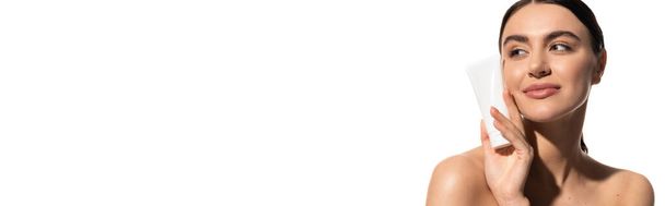 happy young woman with bare shoulders holding tube with body lotion isolated on white, banner  - Foto, afbeelding