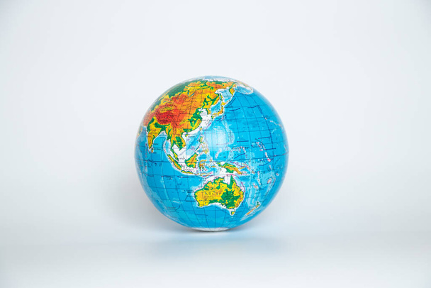 Globe in Ukrainian on a white background close up - Фото, изображение