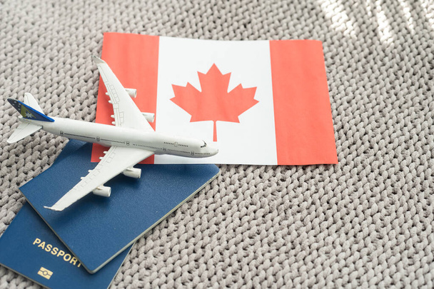 Top view of passport, toy plane, flag of Canada. - Foto, immagini