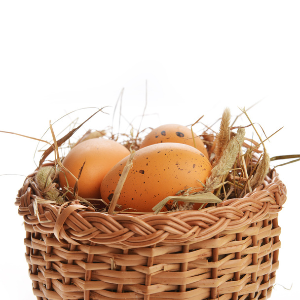 Chicken brown eggs in wicker basket - Фото, изображение