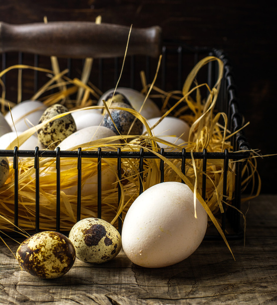 Basket of freshly laid  eggs lying on straw in the barn - Φωτογραφία, εικόνα
