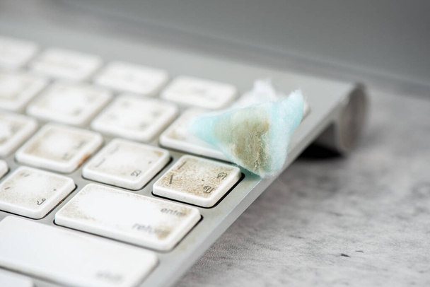 The man cleaning his computer keyboard. Grimy, more bacteria on keyboard. - Foto, Bild