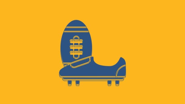 Синий Socho или футбольные туфли со значком speces на оранжевом фоне. Американские футбольные ботинки и мяч. Видеографическая анимация 4K. - Кадры, видео