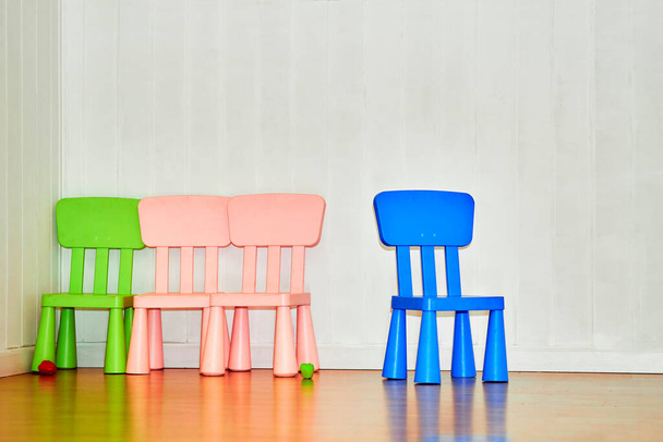 Multi colored children's chairs in the playroom in kindergarten                                - Photo, image